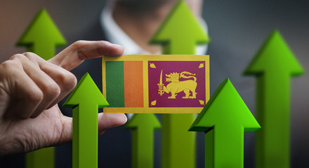 Nation Growth Concept, Green Up Arrows - Businessman Holding Card of Sri Lanka  Flag