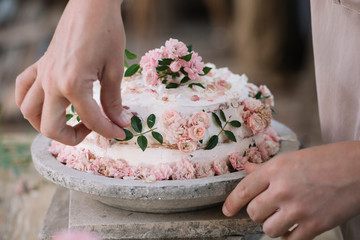 Person decorating Pavlova cake