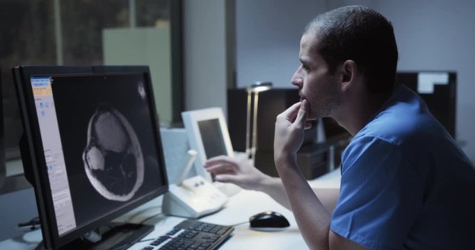 Health Care Male Worker In Hospital With Computer And Equipment