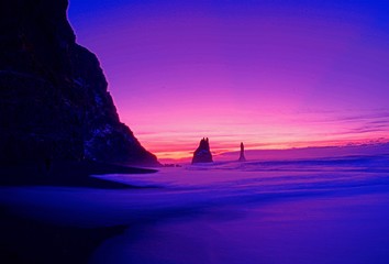 Pink and purple landscape with silhouette cliffs 