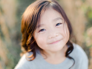 Little girl standing in a soy bean field