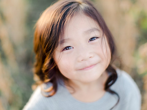 Little girl standing in a soy bean field