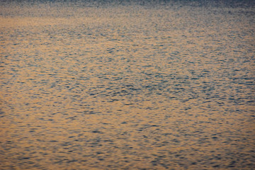 Colorful sunset light on sea water, backgroun or texture