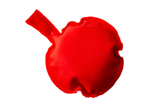 April Fool's Day and vintage practical joke toy concept with a fart cushion isolated on white background with a clip path cutout