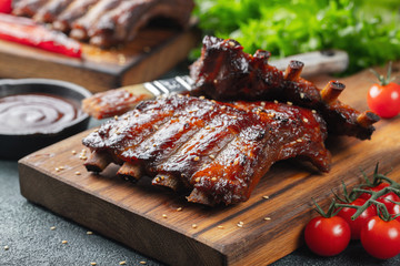 Closeup of pork ribs grilled with BBQ sauce and caramelized in honey. Tasty snack to beer on a...