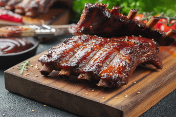 Closeup of pork ribs grilled with BBQ sauce and caramelized in honey. Tasty snack to beer on a...