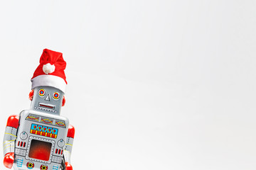Vintage robot retro classic toy with Christmas hat on white background