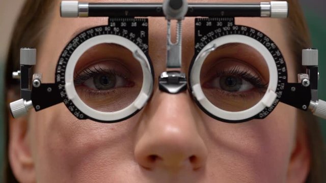 Woman at the reception of an ophthalmologist. Eye examination and selection of spectacle lenses