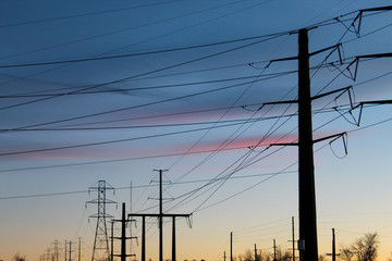 power station pylons and wires in front of sunset