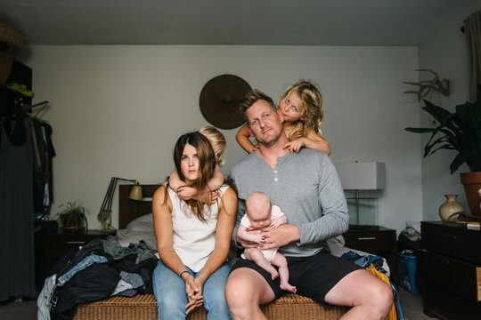 Naklejki Young family with three kids, crying baby and stressed out paren