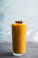 Fresh persimmon smoothie with banana and spices. Selective focus. Shallow depth of field.