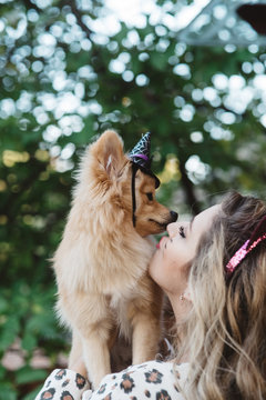 A teenage girl and her dog dressed up for halloween