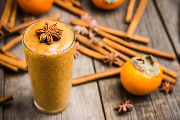 Fresh persimmon smoothie with banana and spices. Selective focus. Shallow depth of field.