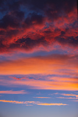 dramatic blue sky with orange clouds at sunset. vertical allignm