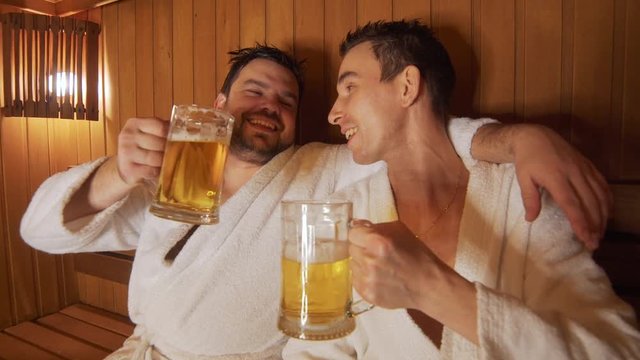 Men relax in the bath, sauna, drink beer