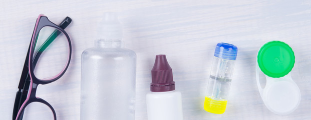 set of items for the care of contact lenses, for eyes, on a light gray background