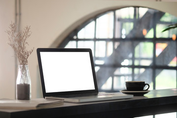 Fototapeta premium Mockup laptop computer on blur cafe background.