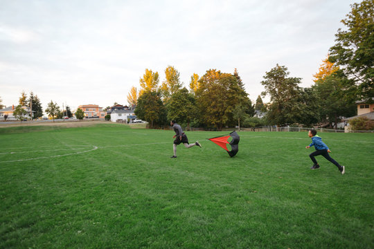 Man and boy enjoying speed parachute training together in field 
