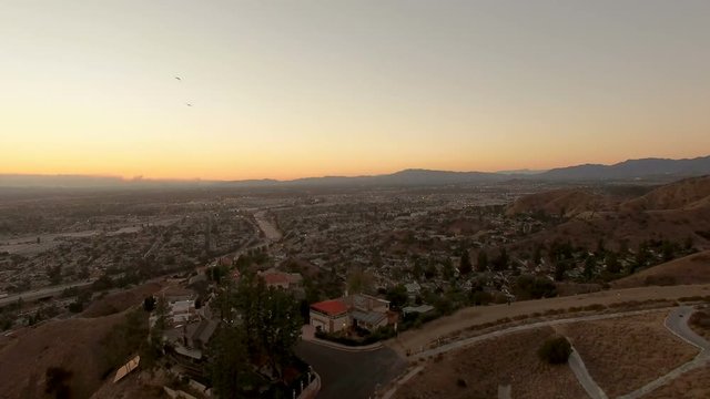 Drone pan shot over California homes and hiking trails at sunset