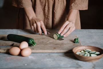 Woman slising small zucchini