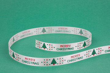 Ribbon printed with Christmas tree on green background