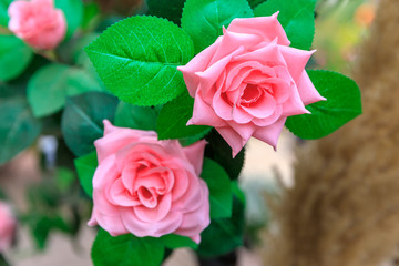 Two synthetic roses