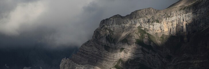 Fototapeta na wymiar Mountain Wall And Clouds