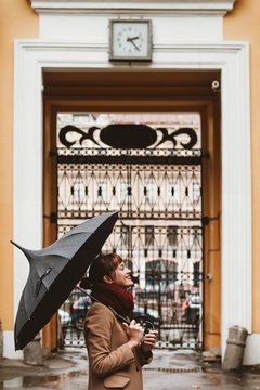 Happy young woman with an umbrella
