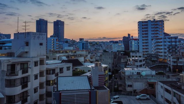 Tilt up time-lapse cityscape shot of Kokusai dori area in Naha. Shot in the morning from dark sky before sunrise until fully blue sky. Okinawa, Japan, April 2018.