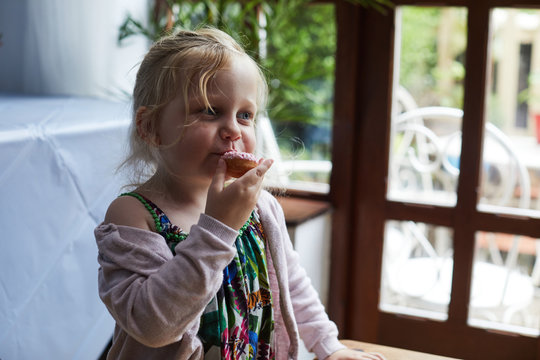 Child Eating A Doughnut