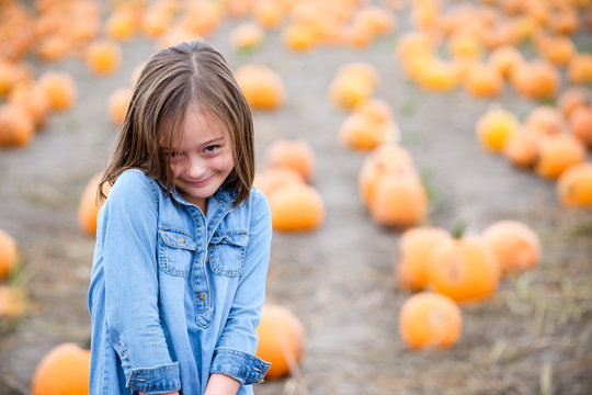 Little girl in a pumpkin patch