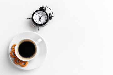 Still life , vintage alarm clock and coffee cup on white table