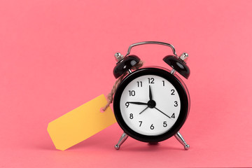 Vintage alarm clock on a bright pink background