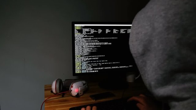Hacker programs in the command line, the monitor glows in the dark, 4k