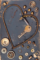 Heart shape made of metal zipper, key, buttons and other garbage. Technical abstract for Valentines day or any other romantic event.
