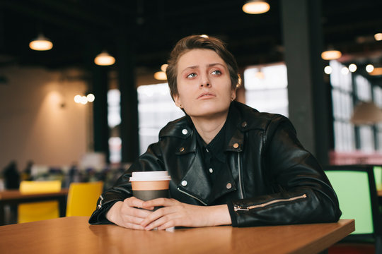 portrait of young tomboy sitting in fast food