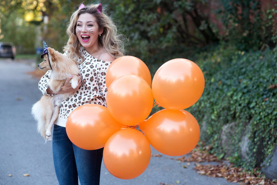A teenage girl and her dog dressed up for halloween