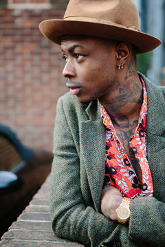Attractive tattoed black millenial man in an urban street