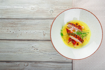 Marinated grilled healthy chicken breasts cooked on a summer BBQ and served with fresh herbs