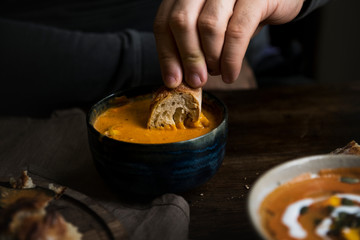 Man eating a creamy pumpkin soup