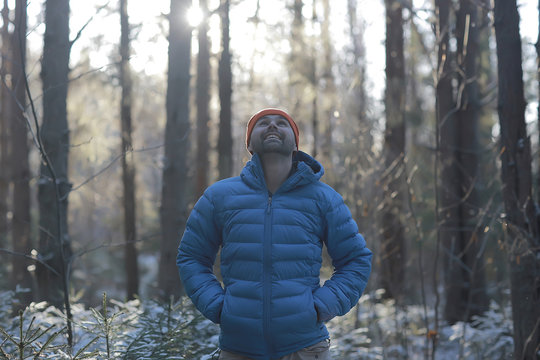 man in sports down jacket landscape winter trekking / down jacket on a tourist, outdoor activities in the north, seasonal landscape
