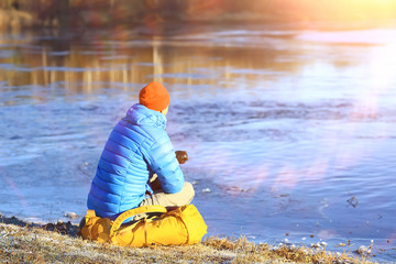 man in sports down jacket landscape winter trekking / down jacket on a tourist, outdoor activities in the north, seasonal landscape