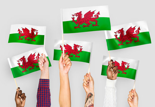 Hands waving flags of Wales