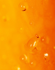 Drops of juice on pumpkin pulp as abstract background