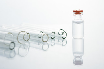 Group of vials with medication on blue methacrylate table.