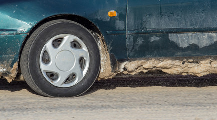 Car wheel in the snow in winter