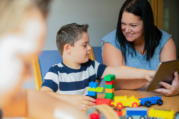 Mother teaching son from a tablet