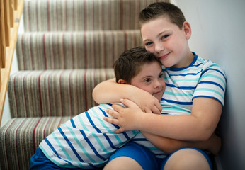 Brothers hugging at the stairs