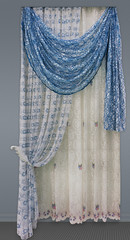 Curtains of the openwork fabric with a floral ornament,  the blue pelmet, and the tulle with...