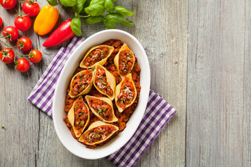Italian pasta Conchiglioni Rigati stuffed with dry tomatoes and meat.
